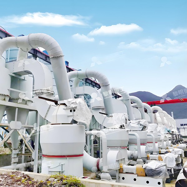 A modern limestone primary crushing plant with a jaw crusher and conveyor system, feeding material into a storage hopper.