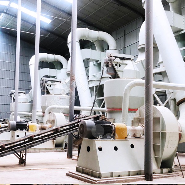 Operator monitoring a digital control panel for a grinding line at a kaolin processing plant