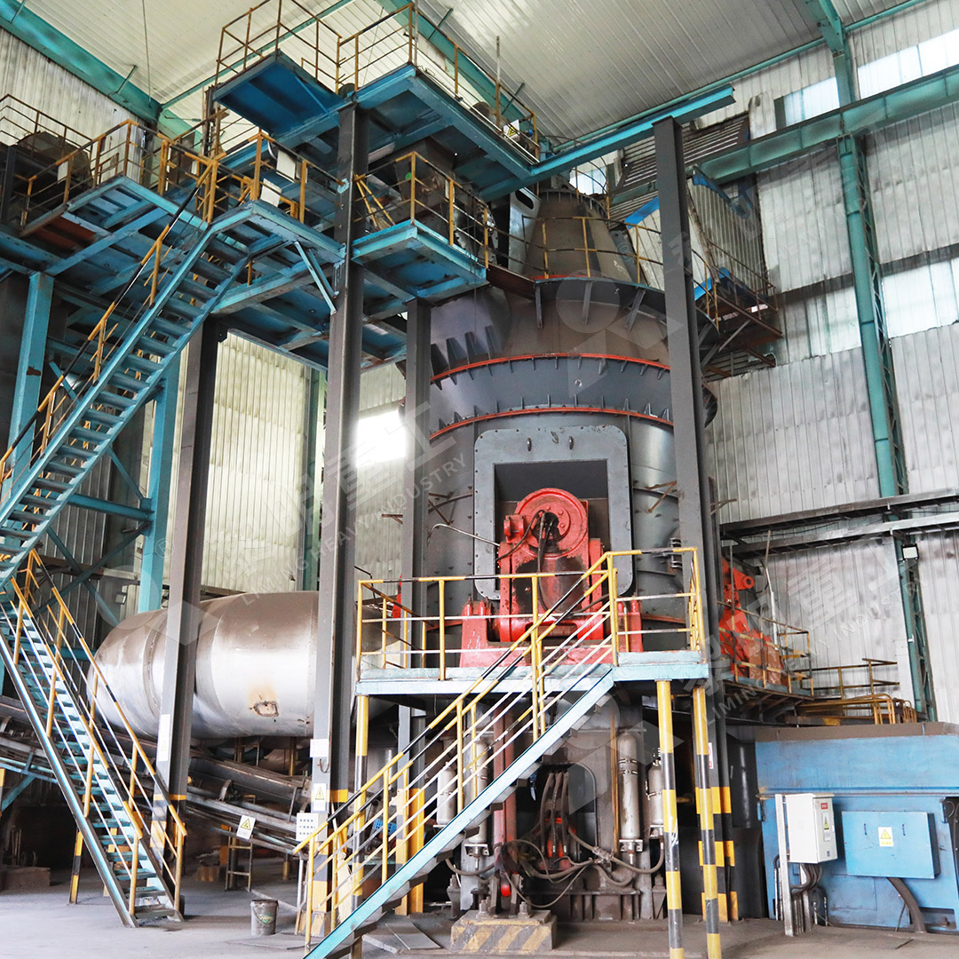 A coal grinding mill installed in a brick production facility, showing the mill body and pipeline connections